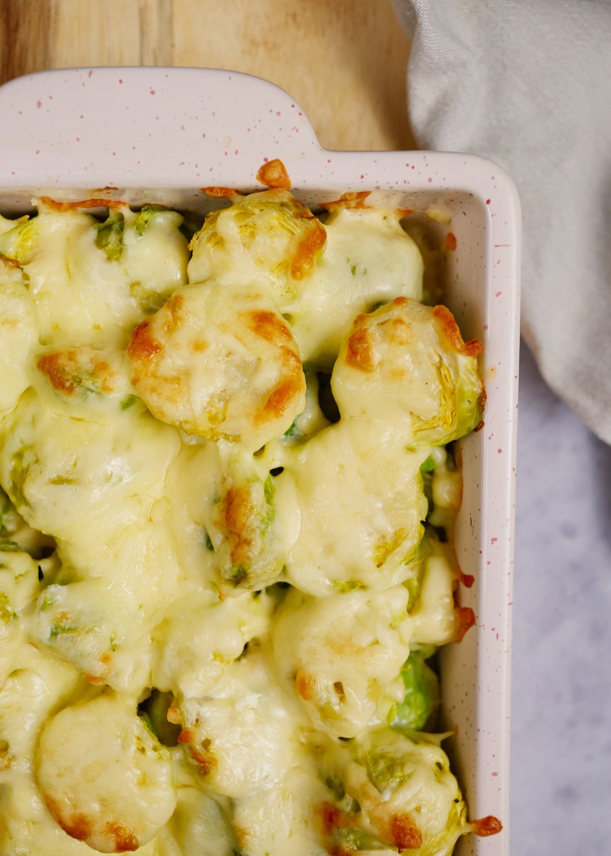 baked creamy brussel sprout casserole in a pink baking dish