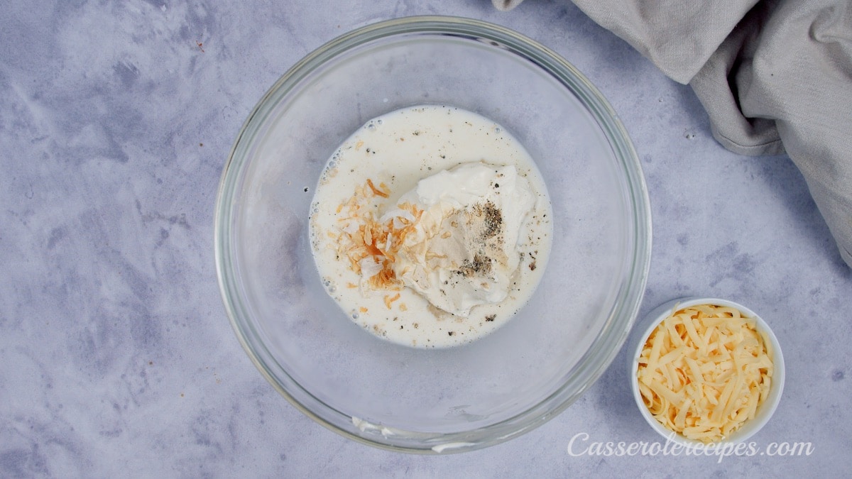 cream cheese, milk, and spices in glass bowl