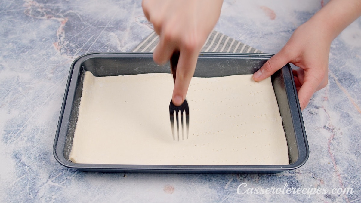 poking crescent roll dough with a fork