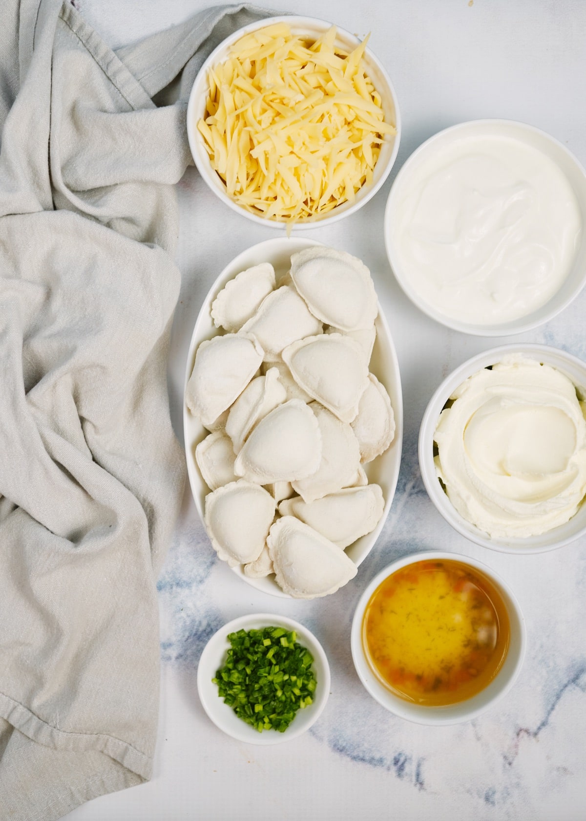 ingredients for creamy pierogi casserole in small bowls