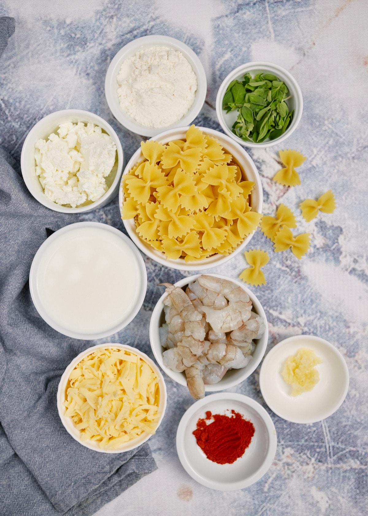 ingredients for creamy shrimp pasta casserole in small bowls