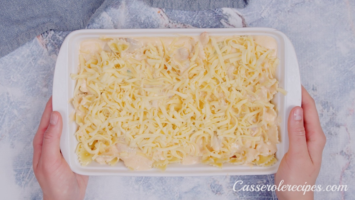 two hands holding casserole before baking