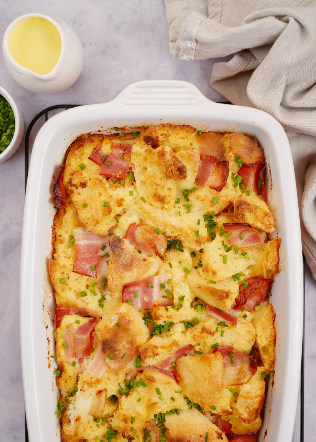 baked eggs benedict casserole in a white baking dish