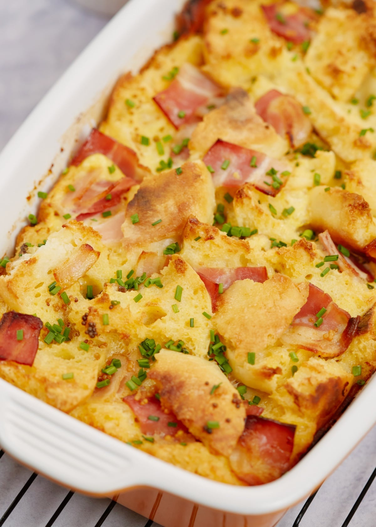 baked eggs benedict casserole in a white baking dish