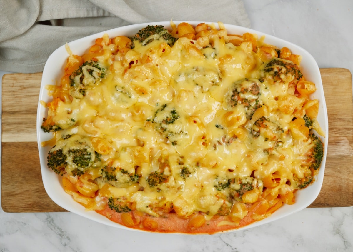 baked gnocchi bean casserole in a white baking dish on a wooden board
