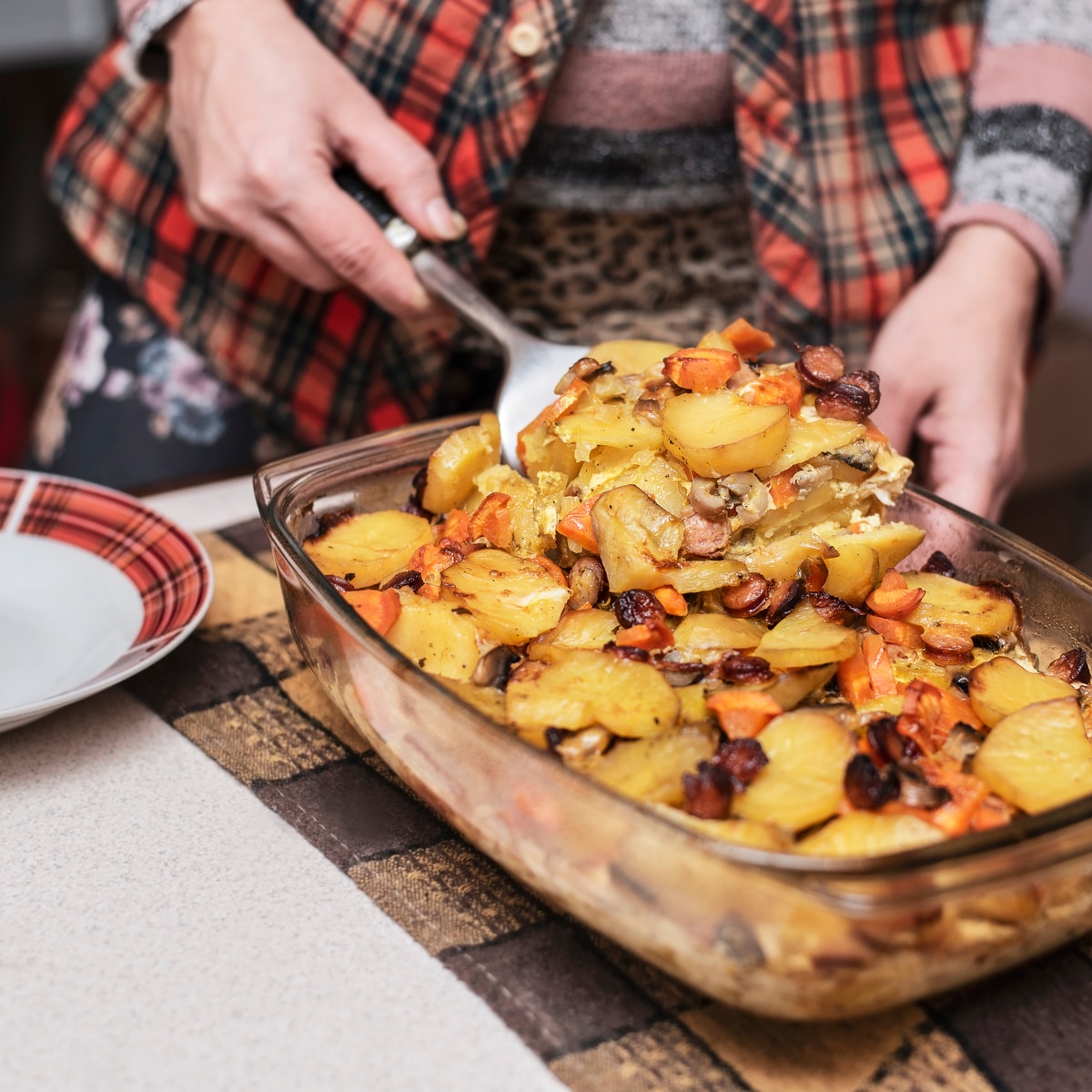 Serving potato casserole.