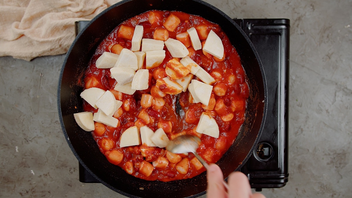 quartered biscuits added to pan with sauce and hot dogs