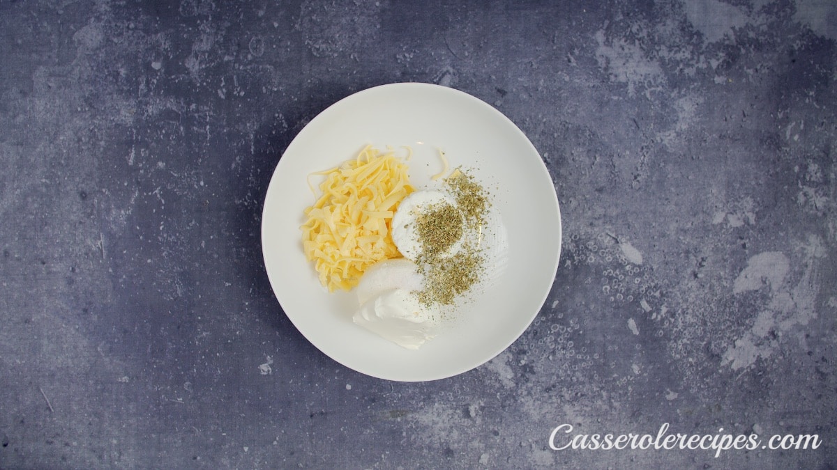 spices, cheese, and herbs in a white bowl