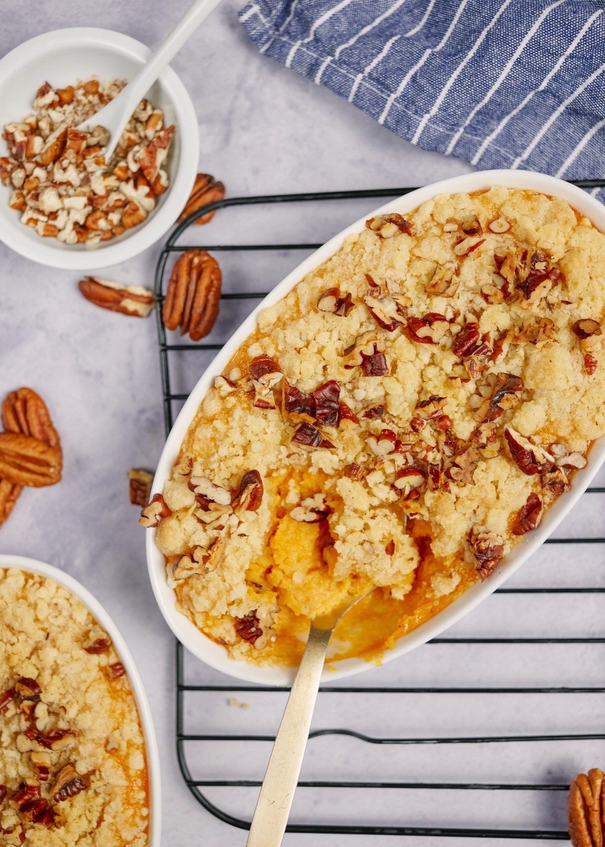 southern sweet potato casserole with a spoon lifting out a scoop of casserole on a cooling rack