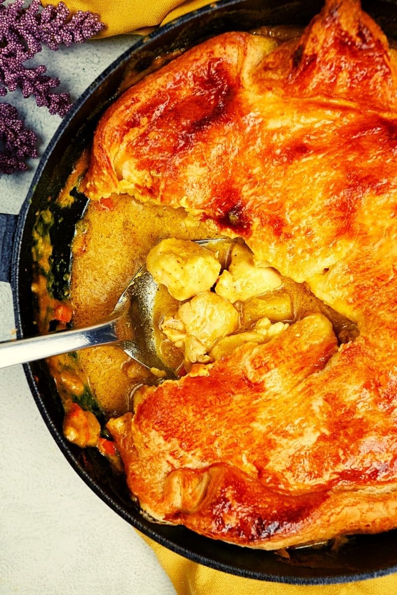 Chicken thigh curry casserole in a cast iron skillet pan.