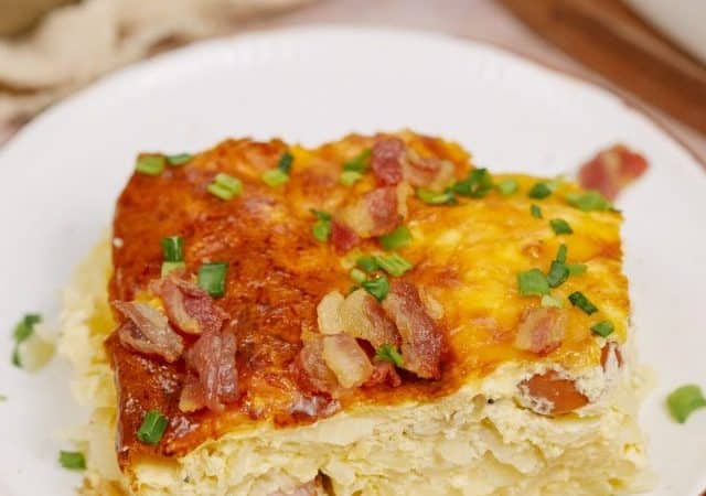 a slice of baked hot dog breakfast casserole on a white plate
