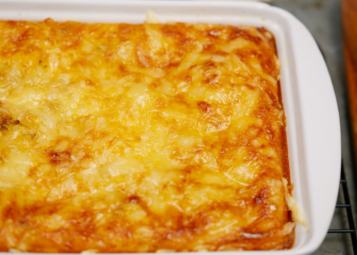 white baking dish filled with breakfast casserole topped with melted cheese