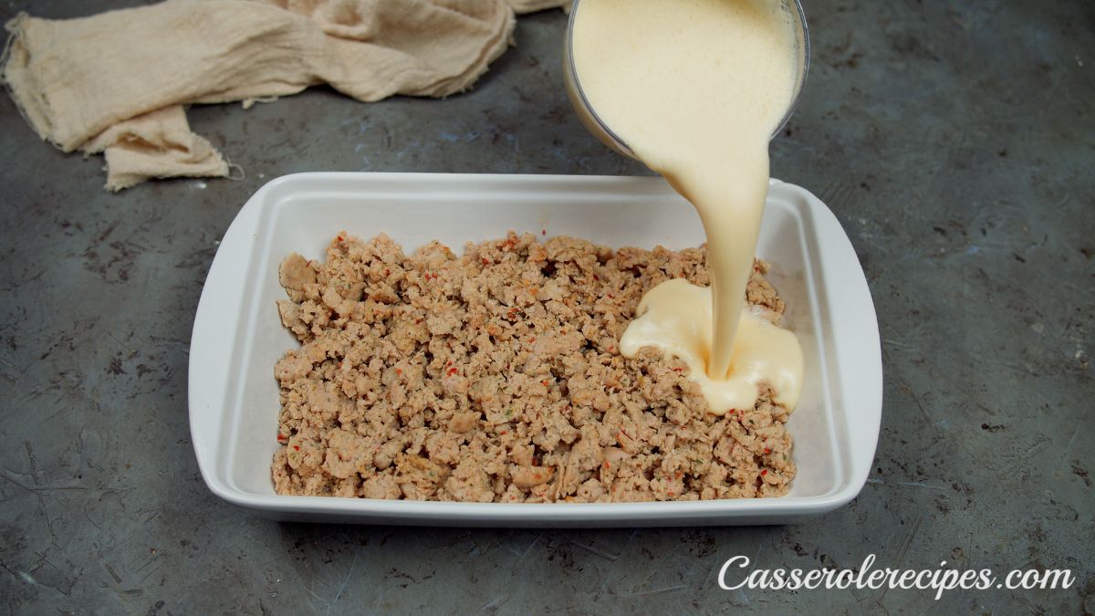 sausage in bottom of baking dish topped with bisquick