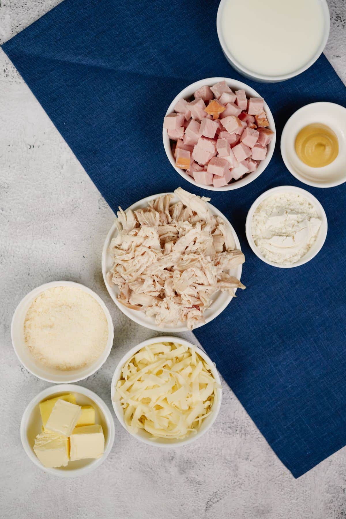 white bowls of ingredients on blue tablecloth