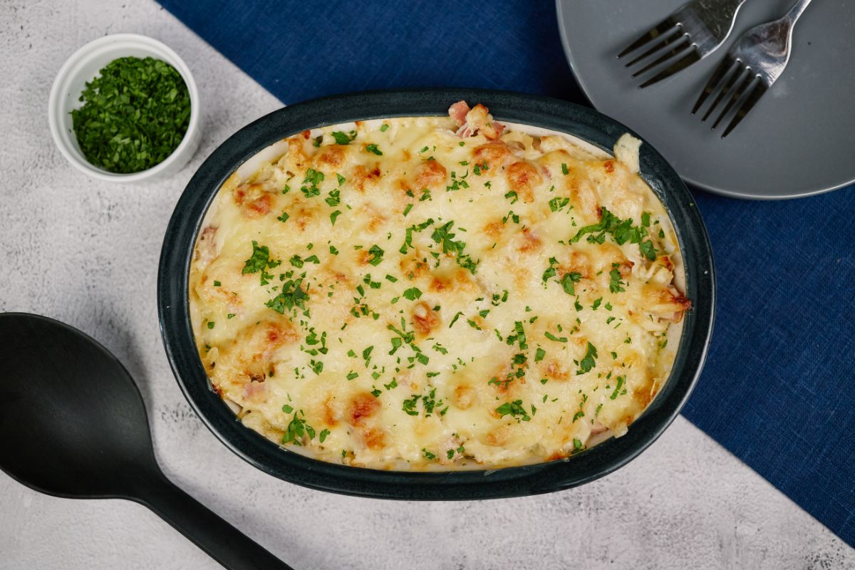 image looking down on top of casserole dish with parsley sprinkled over cheese