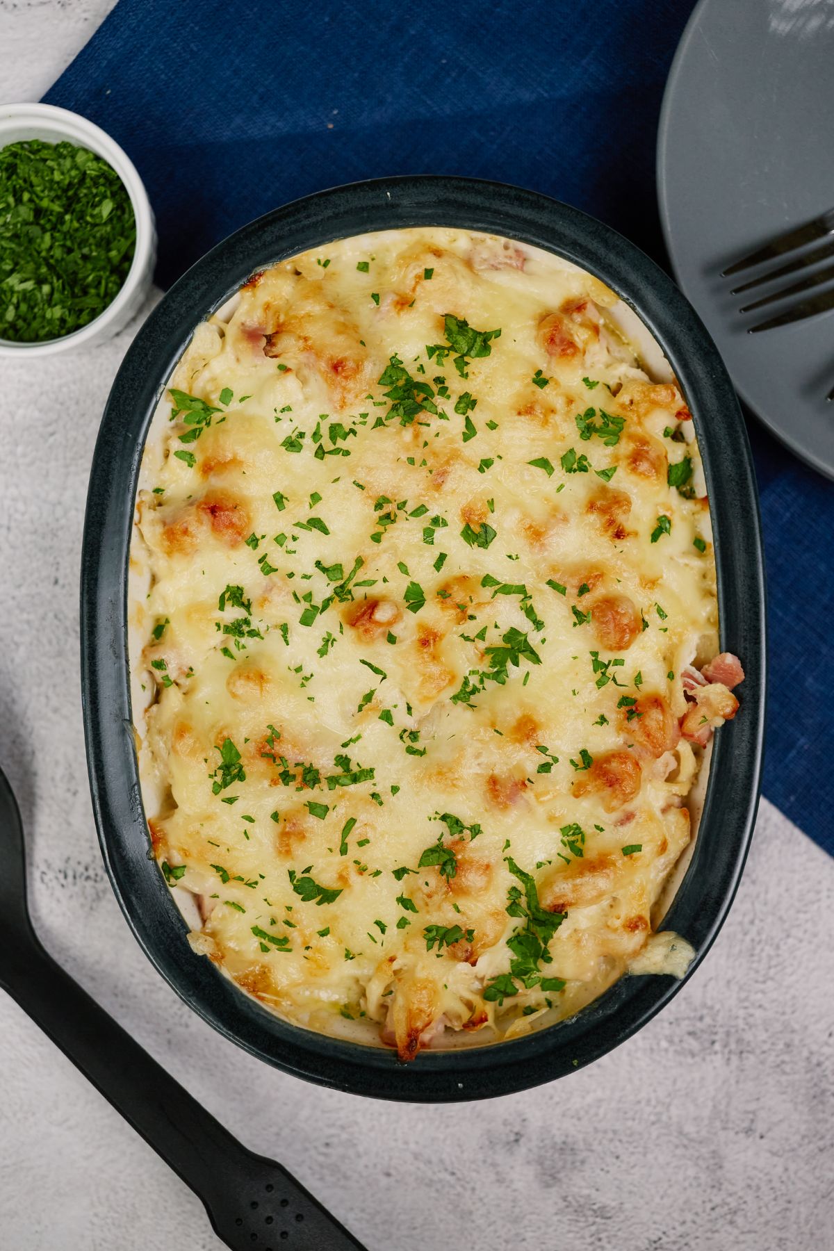 image looking down on baked chicken cordon bleu casserole on tablecloth