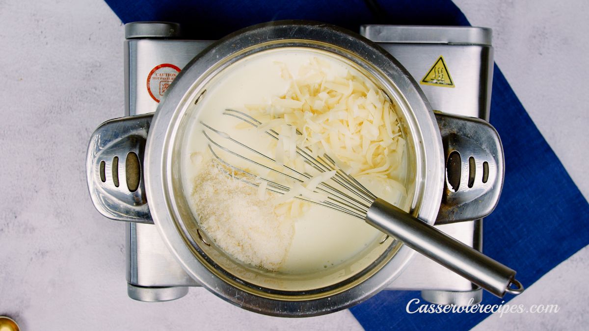 cheese and whisk in saucepan on hot plate