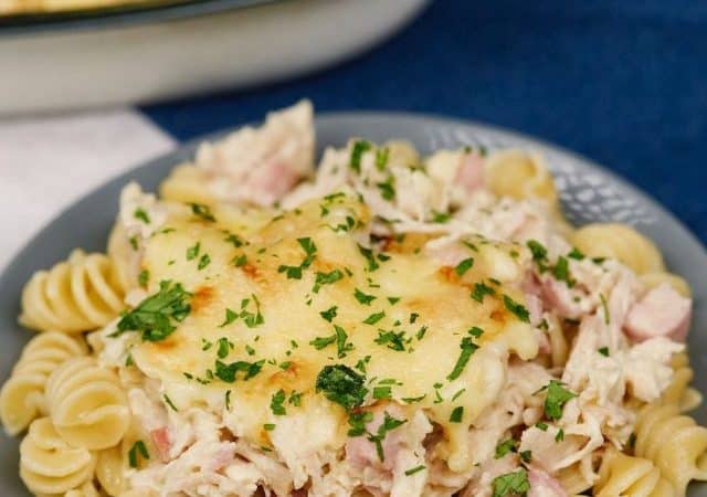 gray plate of chicken cordon blue casserole over pasta