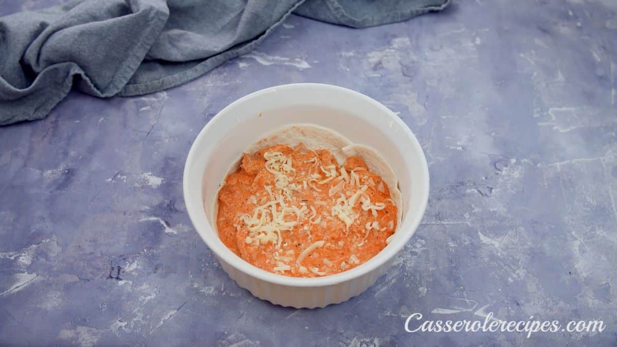 cheese on top of chicken mixture in baking dish