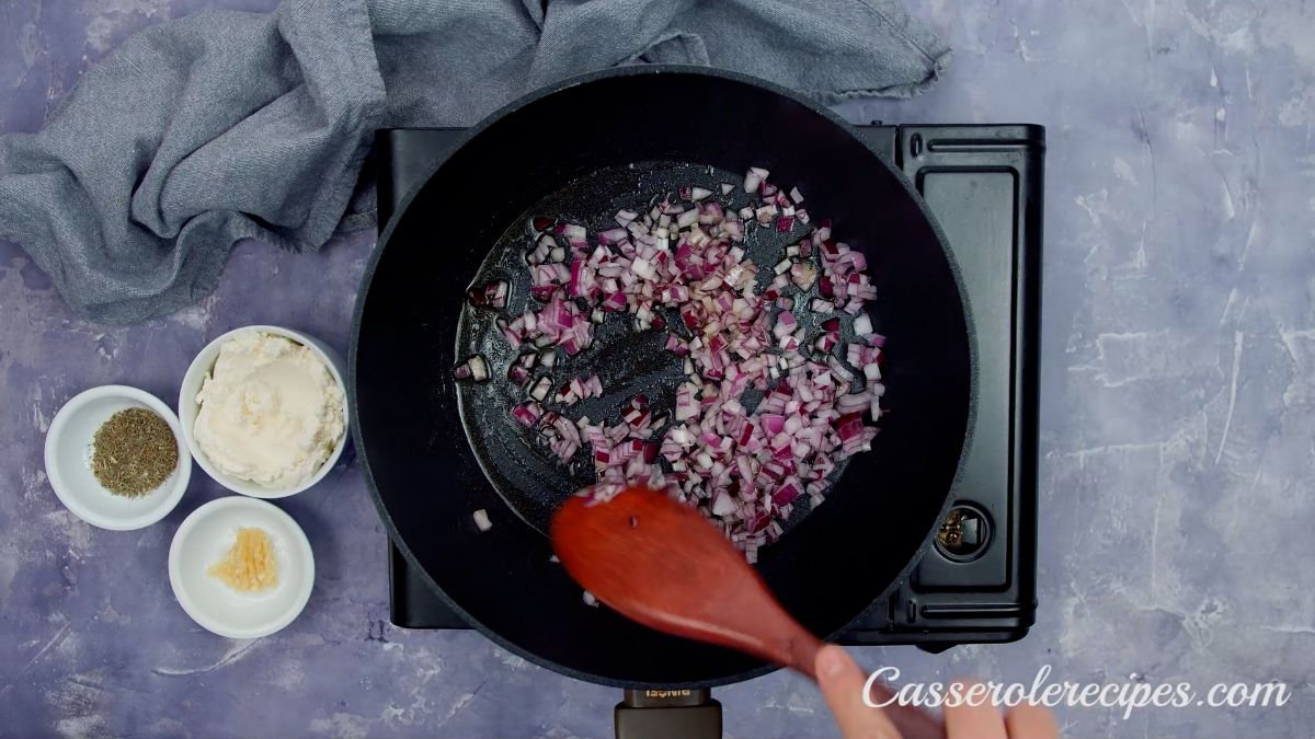 red onion in skillet on hot plate