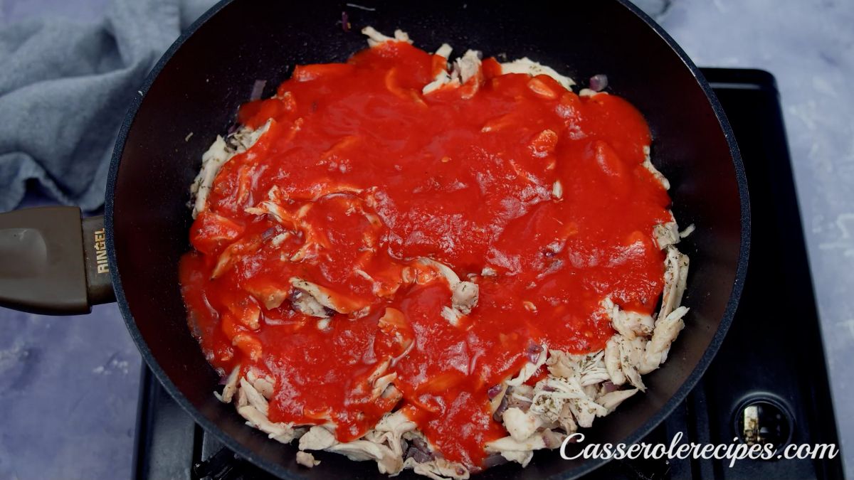 tomato sauce and chicken in skillet