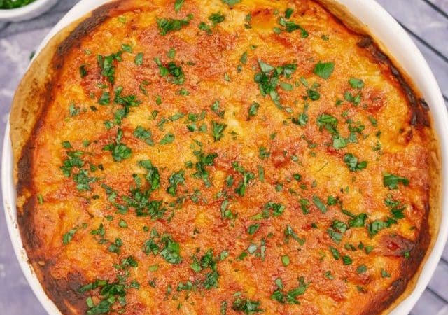 wire rack holding round white dish of chicken tortilla casserole