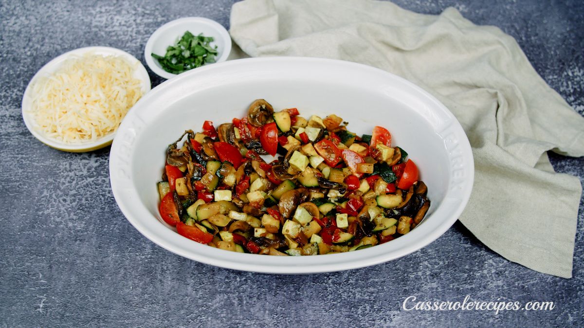 round oval white baking dish of cooked vegetables