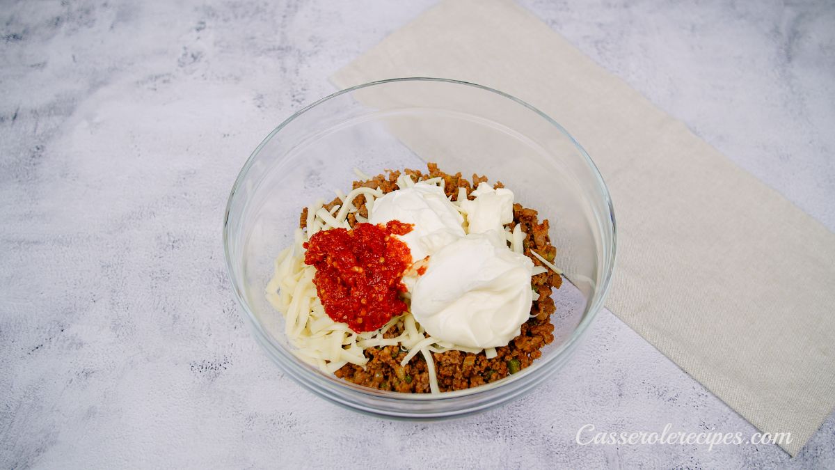 glass bowl of ground meat sour cream and cheese