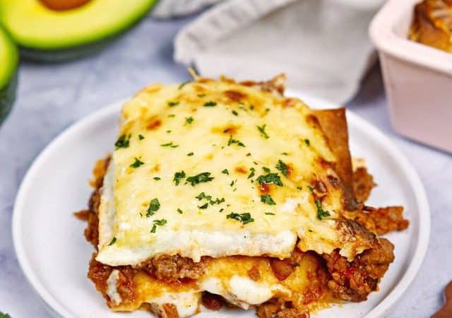 square of burrito casserole on round light blue plate