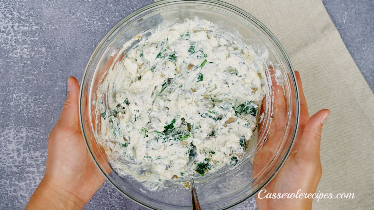 large glass bowl of cheese with spinach