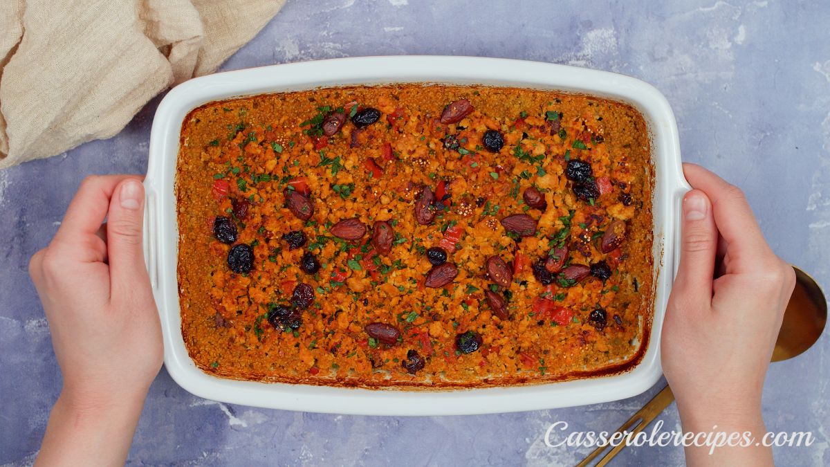 baked ground turkey and quinoa casserole being held above gray table