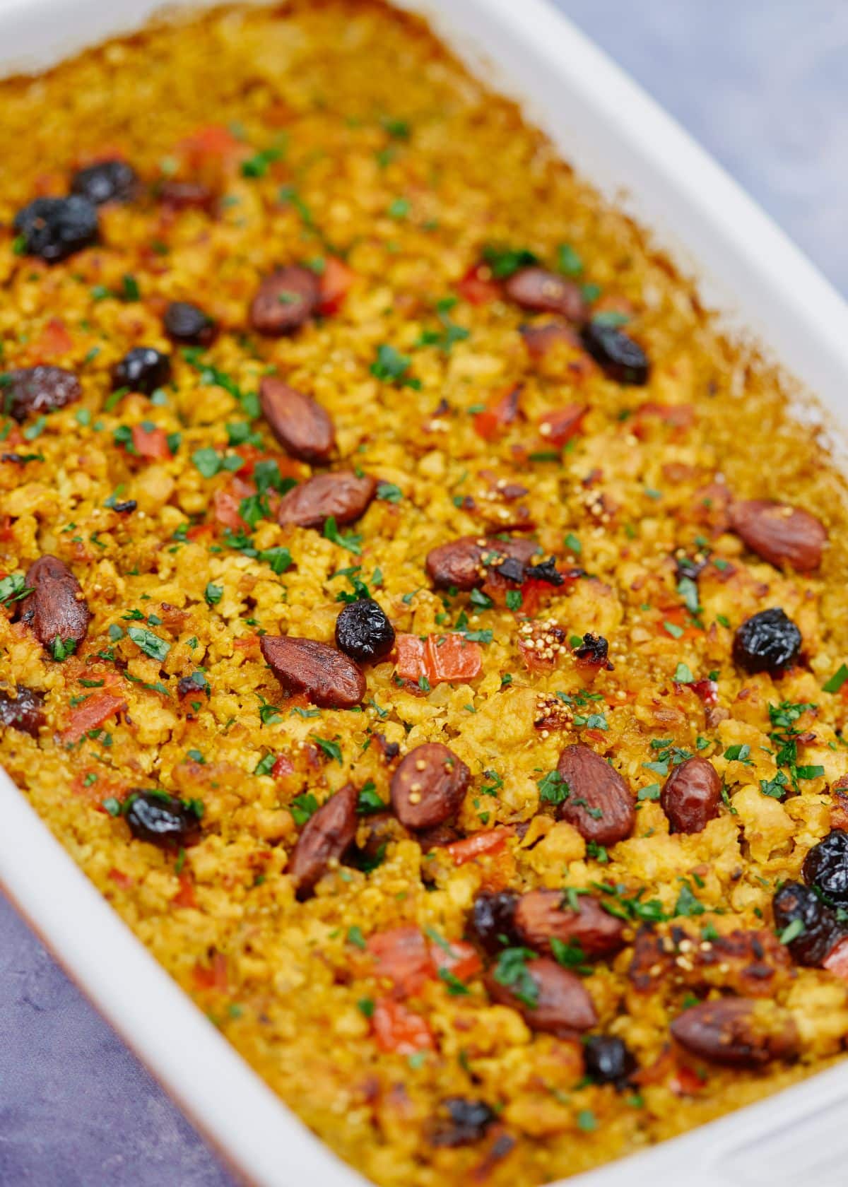 casserole dish of quinoa and turkey with almonds on top