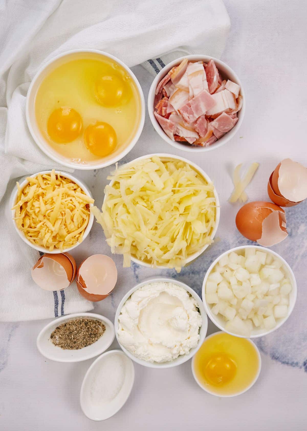 round white ramekins filled with ingredients for breakfast casserole