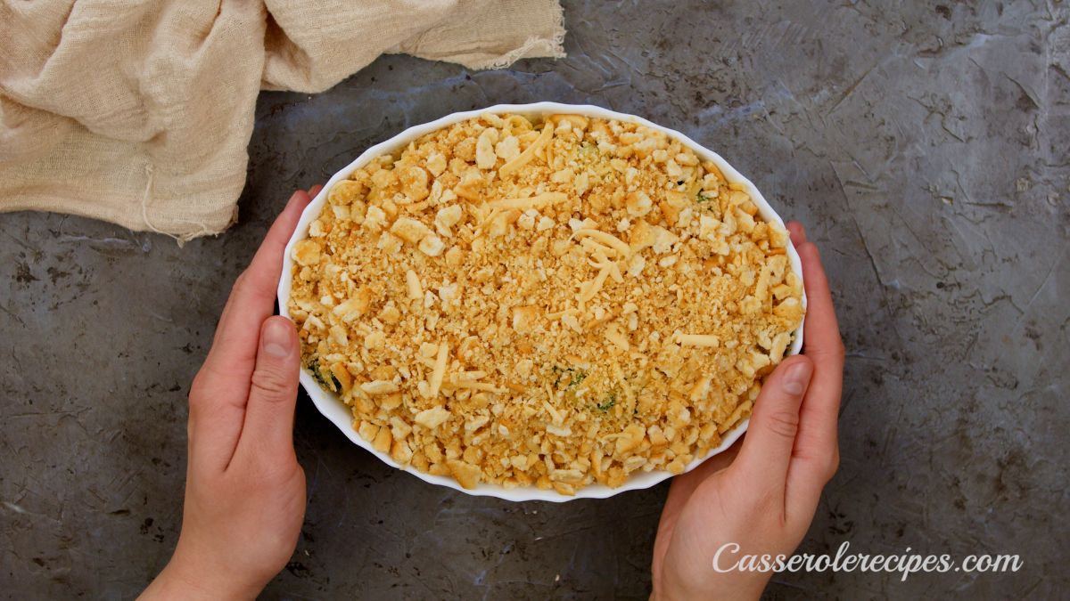 hands holding casserole dish before baking