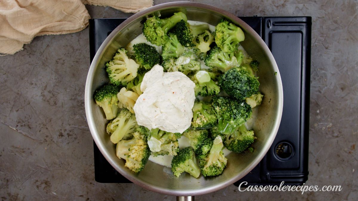 skillet on hot plate cooking broccoli and boursin cheese