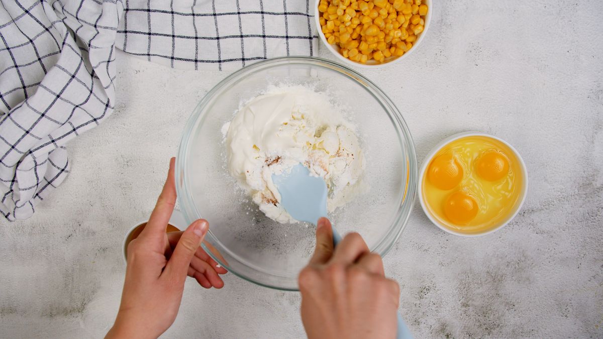 large glass bowl of cream cheese and sour cream on marble table