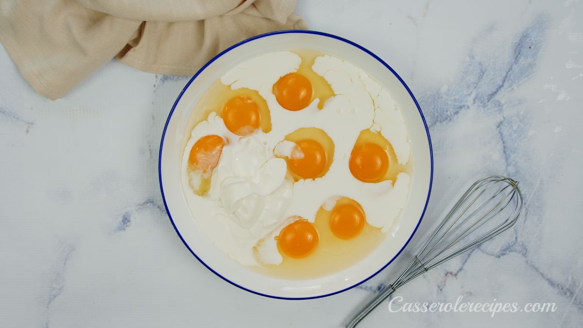 eggs and milk in large white bowl on marble table