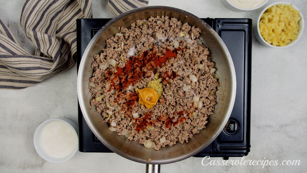 spices on top of cooked ground beef in skillet