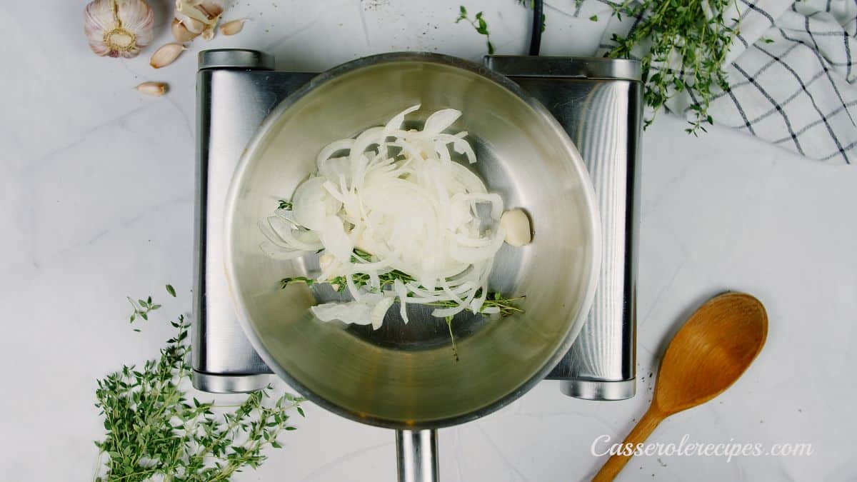 onions garlic and thyme in saucepan