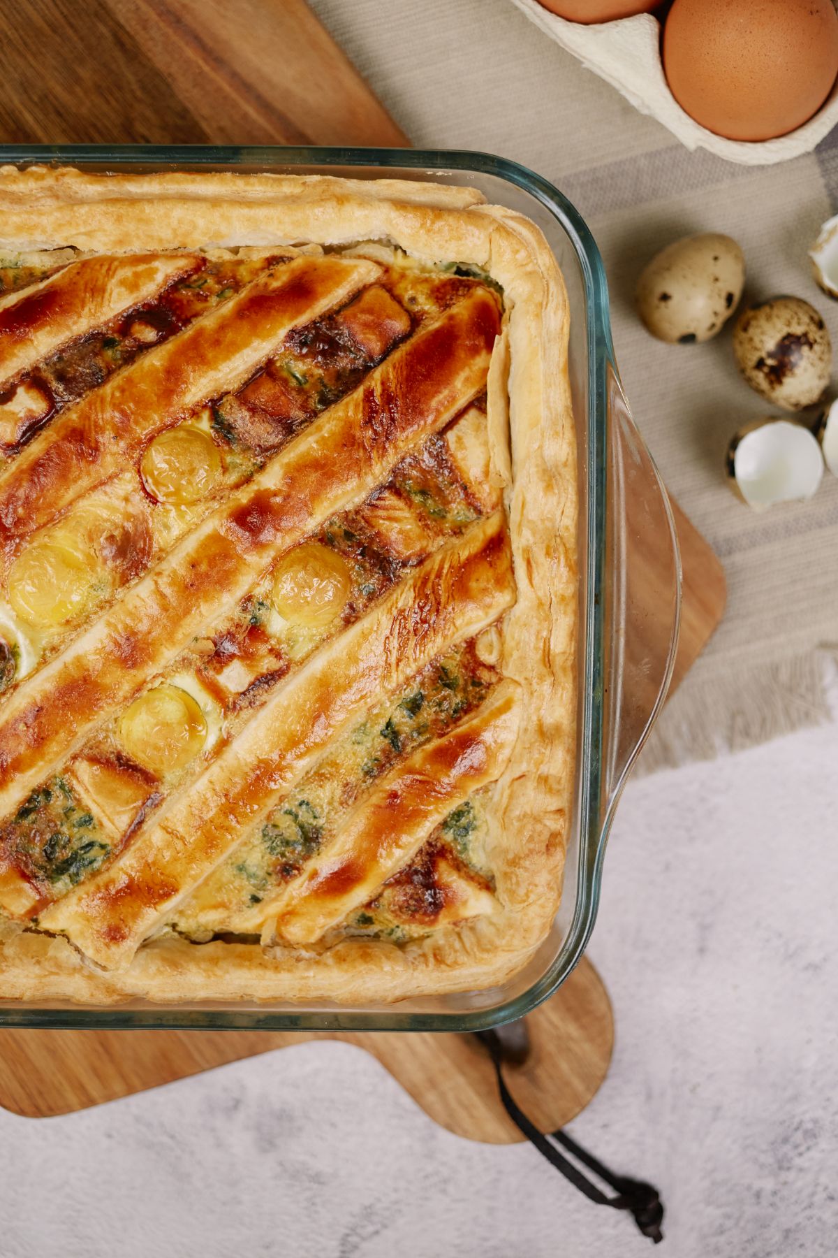 puff pastry crust in glass baking dish of bacon and egg casserole