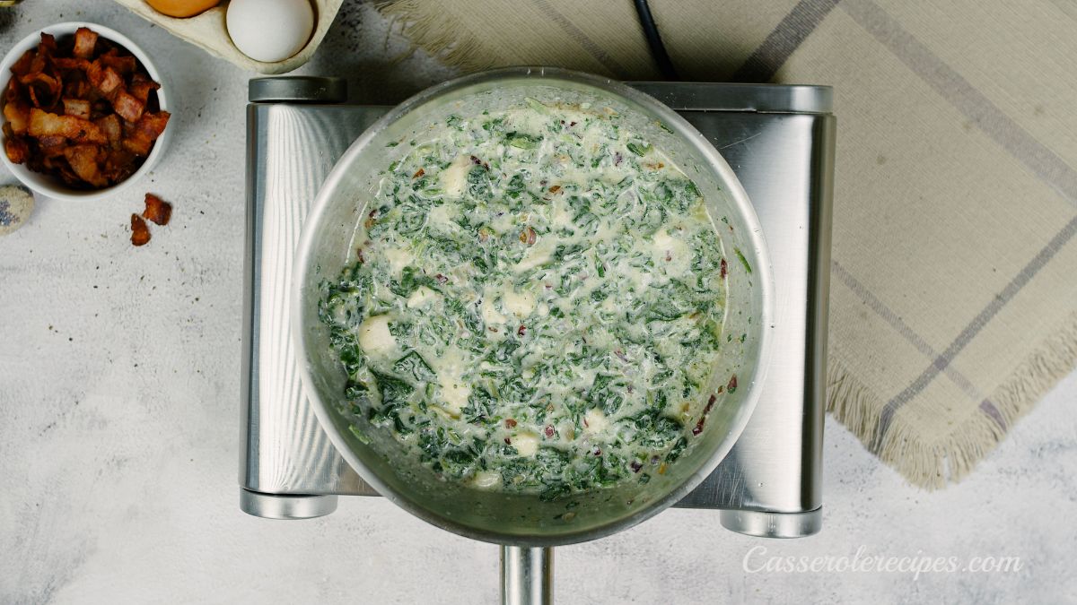 creamed spinach in saucepan on silver hot plate