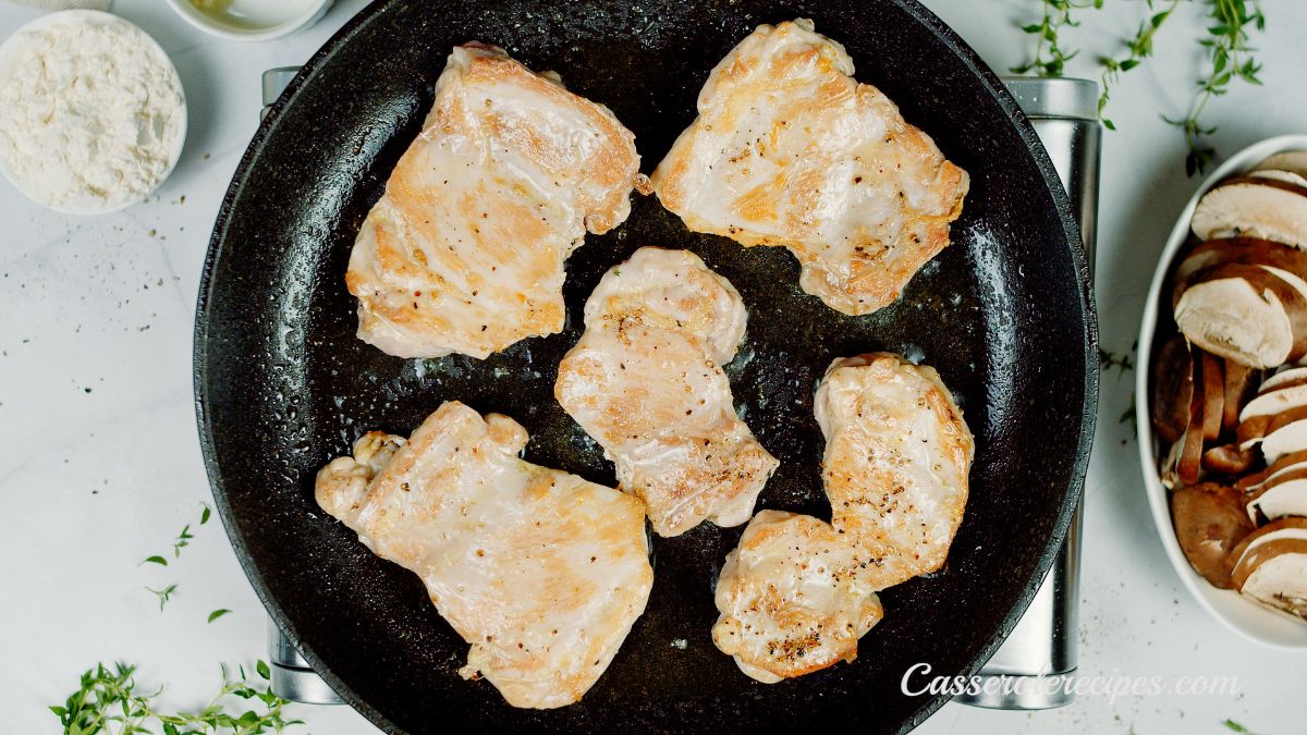 chicken thighs browned in skillet