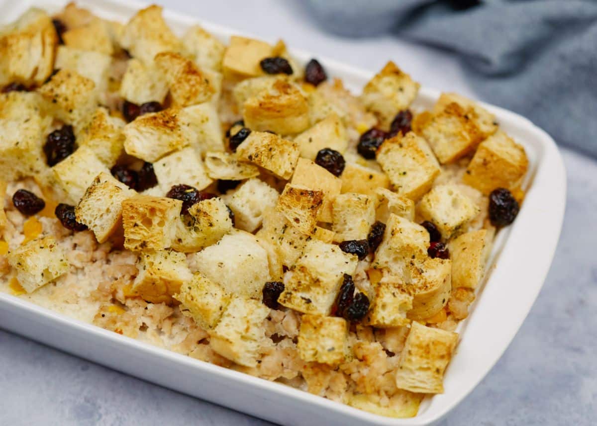 white baking dish of ground turkey casserole topped with toasted bread cubes