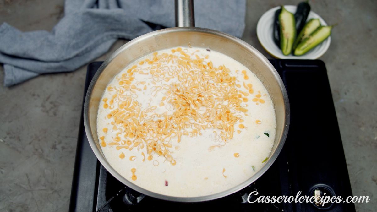pasta in skillet of cream sauce on hot plate