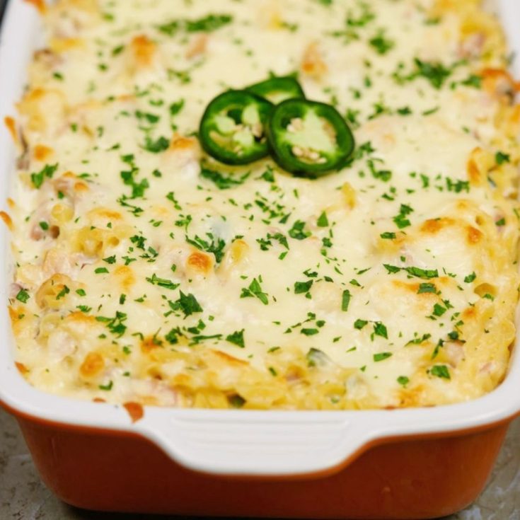 image of red baking dish with white trim filled with jalapeno popper chicken casserole
