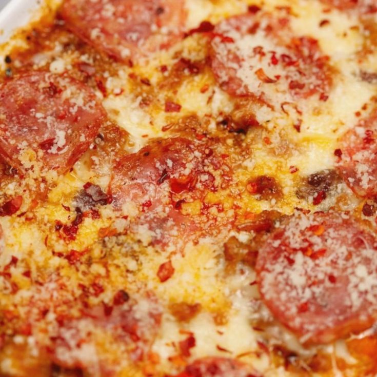 close up image of top of pizza casserole with salami and cheese