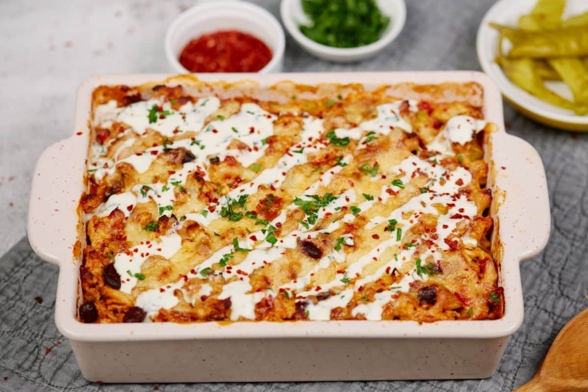 square baking dish of chicken Mexican fiesta casserole topped with sour cream