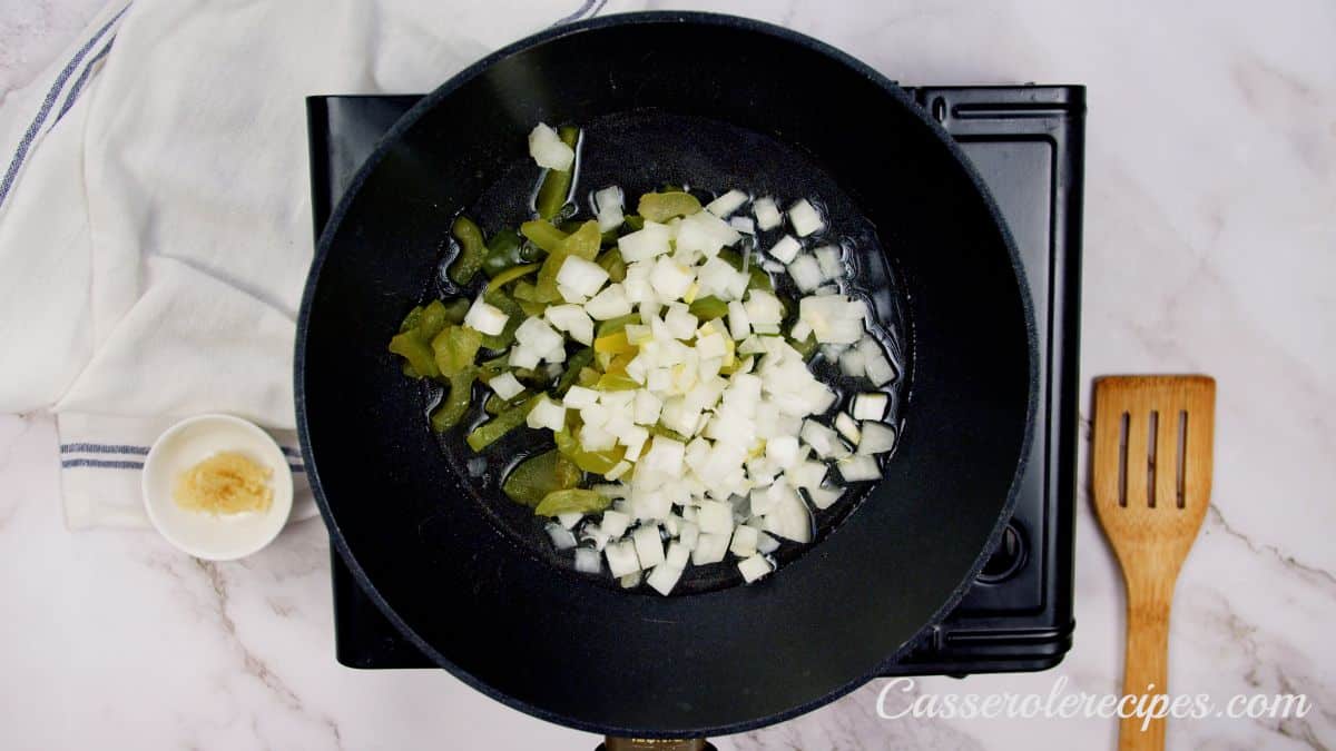 skillet of peppers and onions on hot plate