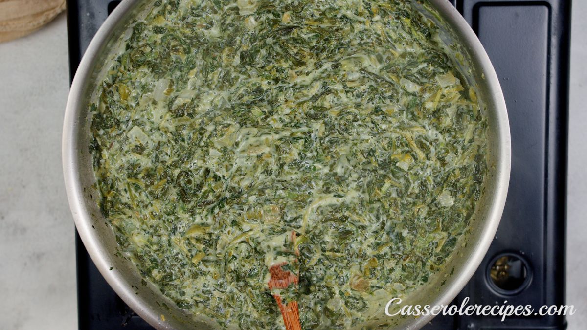 creamed spinach in skillet on black hot plate