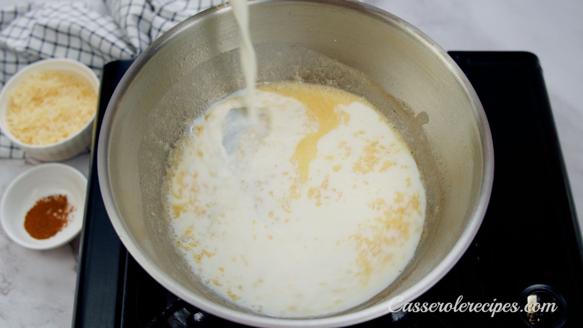 milk being poured into skillet